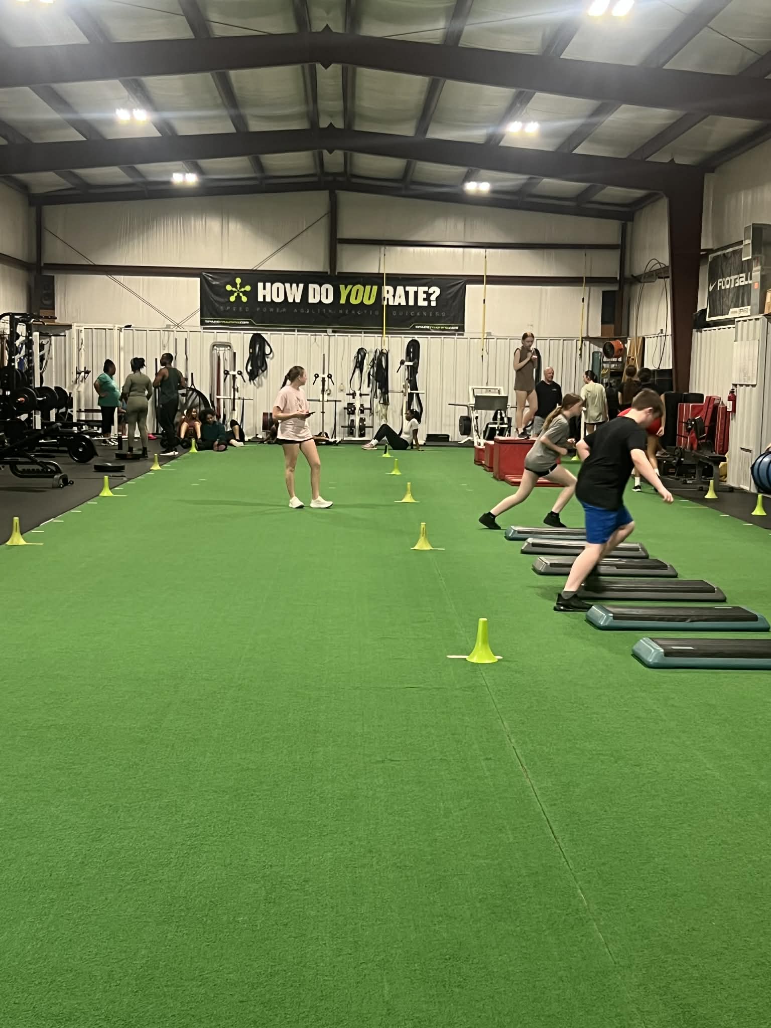 Teenage athletes running agility and step drills during a training session
