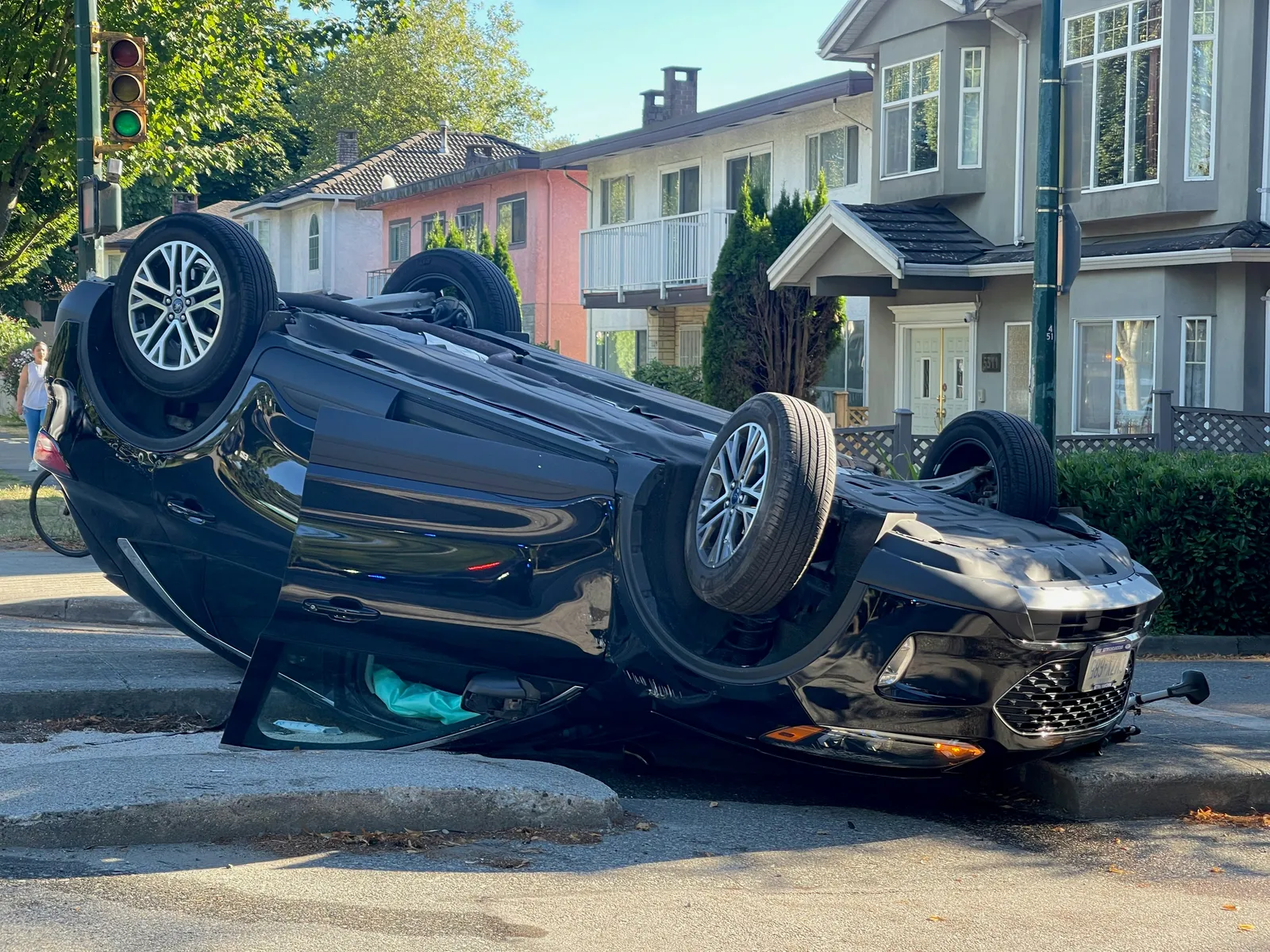 A car flipped onto its roof at a neighborhood intersection after a serious crash