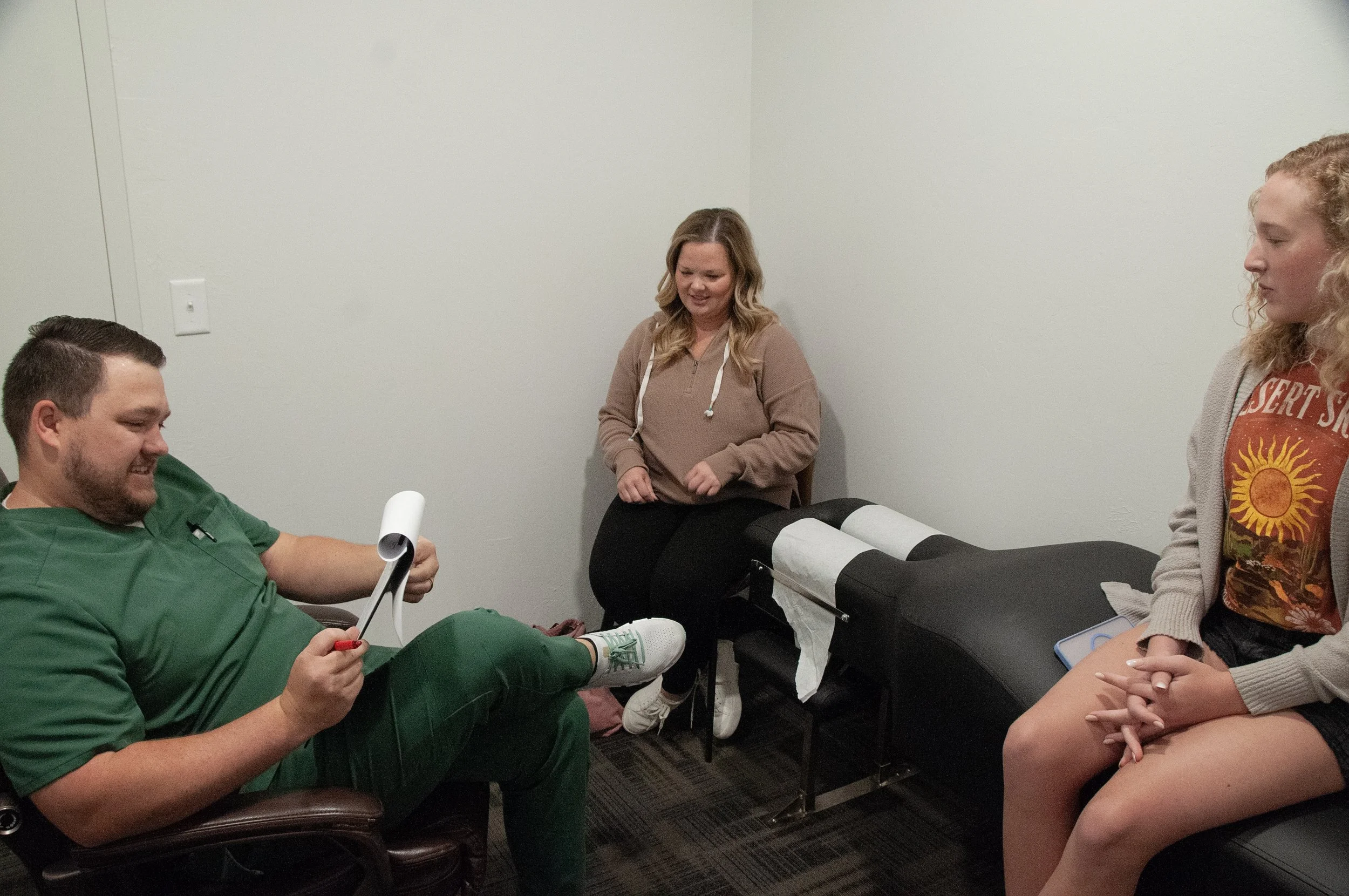 Dr. Jake Edwards listening to a patient during a new patient consultation