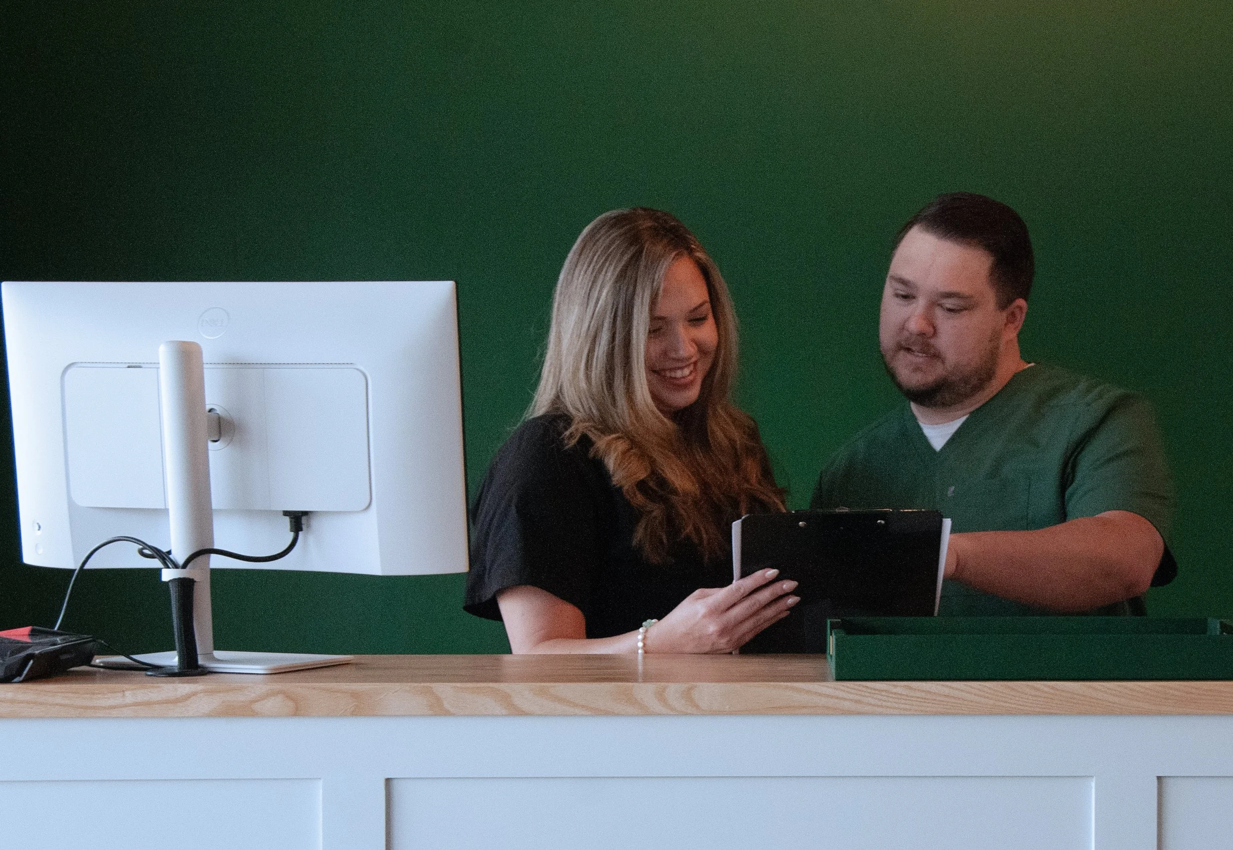 A patient reviewing intake information at the REVIVE front desk