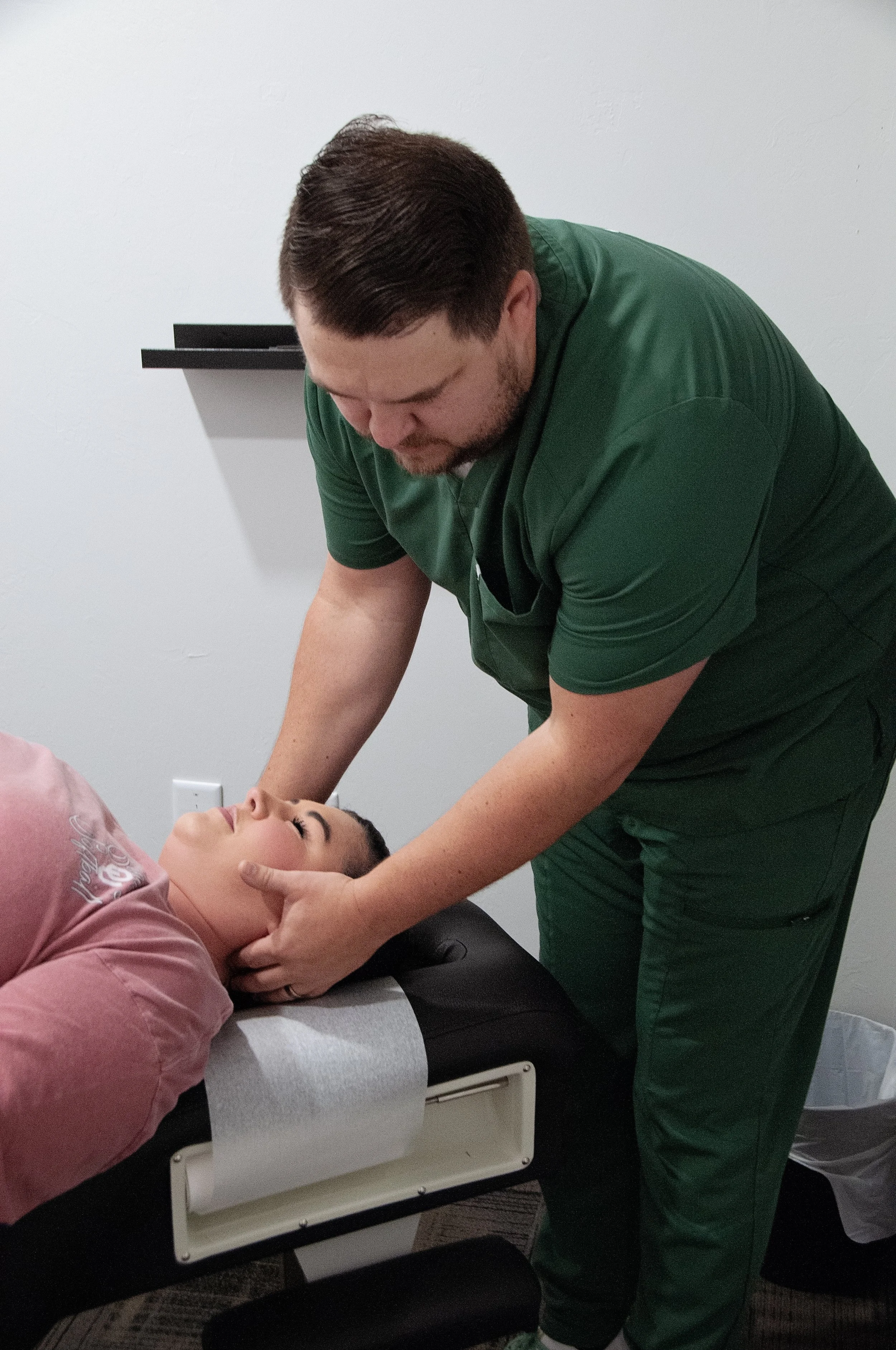 Dr. Jake Edwards demonstrating the gentle, hands-on adjusting style used in prenatal care