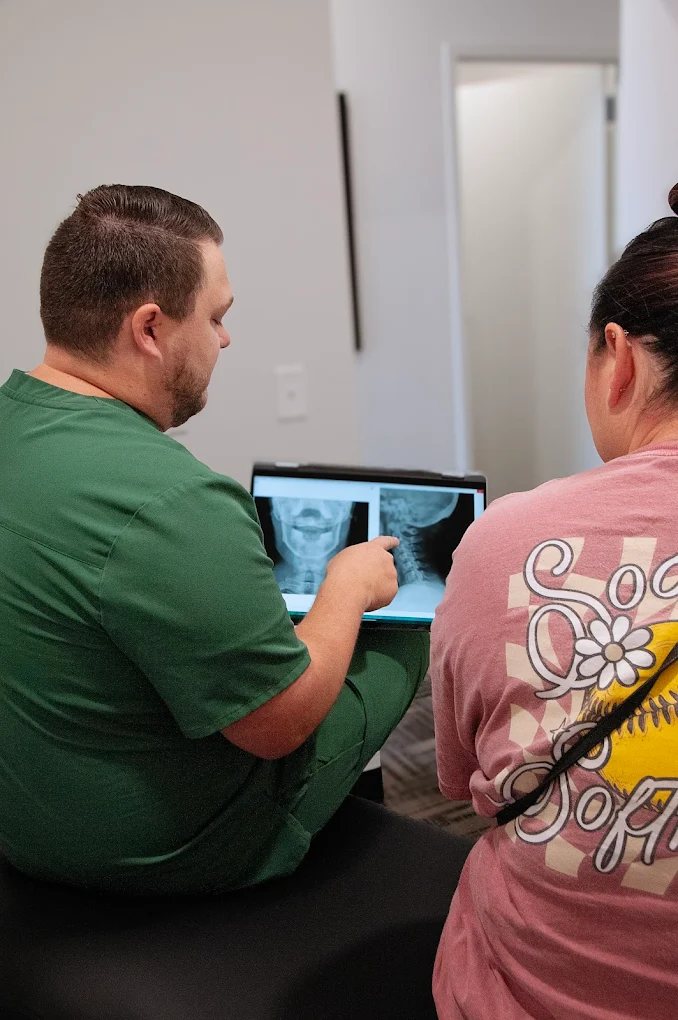 Dr. Jake Edwards reviewing a spinal X-ray with a patient